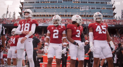 a group of football players wearing red and white uniforms with the number 2 on the back