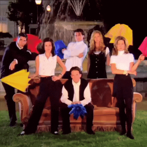 A Group Of Friends Posing For A Picture With Umbrellas In Front Of A Fountain GIF