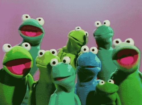 A Group Of Frogs With Big Eyes Are Standing Together GIF