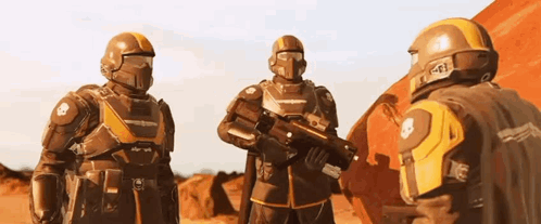 A Group Of Futuristic Soldiers Are Standing Next To Each Other On A Red Planet . GIF