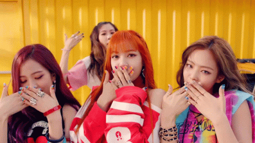 A Group Of Girls Are Covering Their Mouths With Their Hands And One Has A Shirt That Says Supreme On It GIF
