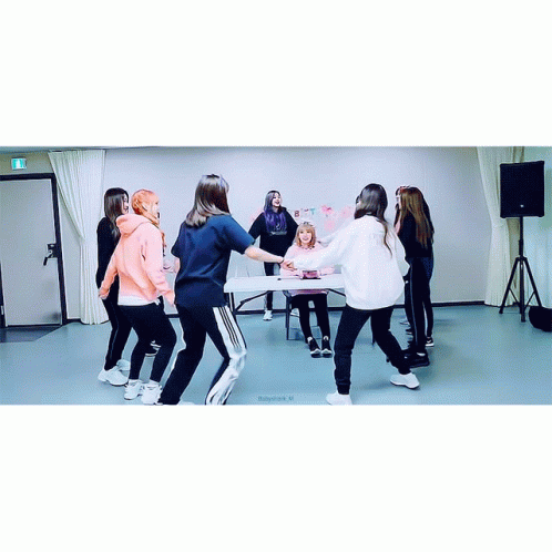 A Group Of Girls Are Dancing In A Room With A Sign On The Wall That Says " I Love You " GIF