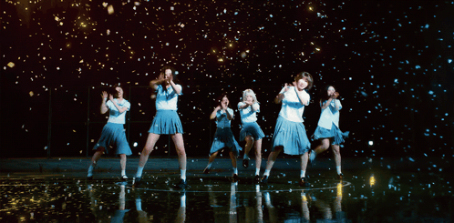 A Group Of Girls Are Dancing In Front Of A Black Background GIF