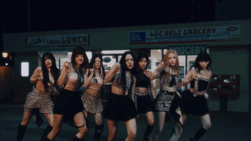 A Group Of Girls Are Dancing In Front Of A Deli Grocery Store GIF