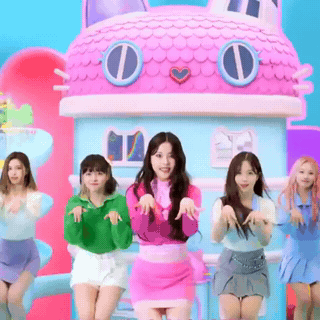 A Group Of Girls Are Dancing In Front Of A Pink Doll House GIF