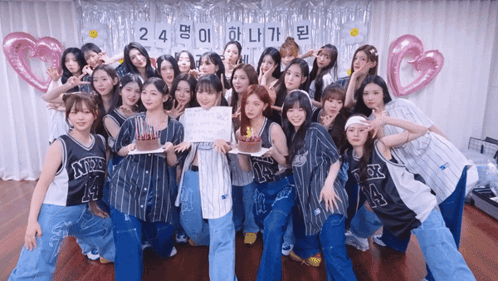 A Group Of Girls Are Posing For A Picture With A Sign That Says 24 GIF