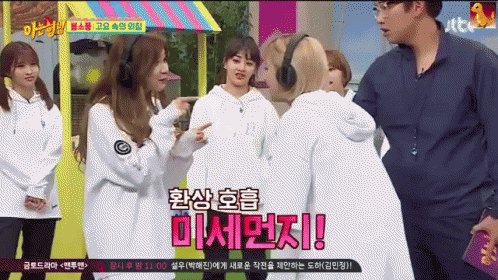A Group Of Girls Are Standing Next To Each Other And One Of Them Is Wearing Headphones And Says ' Twice ' GIF