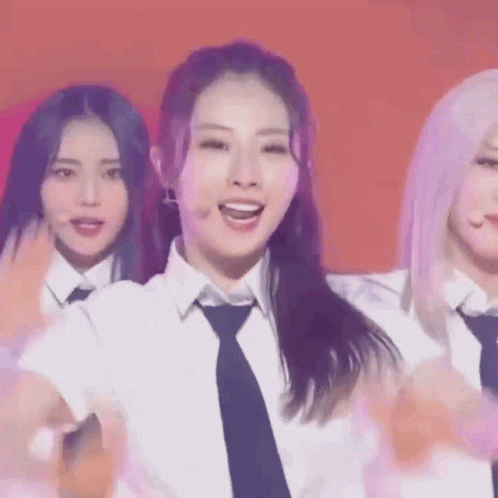 A Group Of Girls Are Standing Next To Each Other On A Stage . GIF