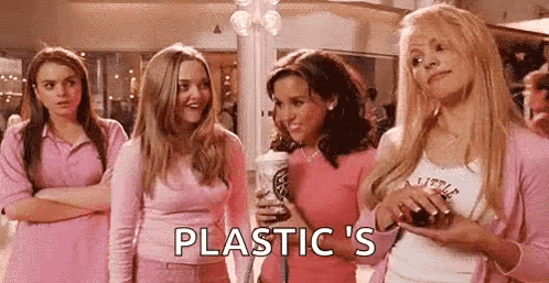 A Group Of Girls In Pink Clothes Are Standing Next To Each Other In A Mall And Talking To Each Other . GIF