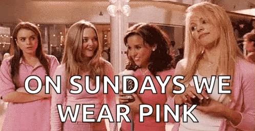 A Group Of Girls In Pink Shirts Are Standing Next To Each Other In A Room . GIF