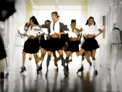 A Group Of Girls In School Uniforms Are Dancing In A Room GIF