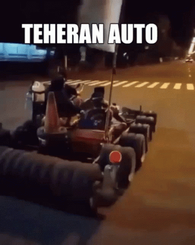 A Group Of Go Karts Are Parked On The Side Of The Road With Teheran Auto Written On The Bottom GIF