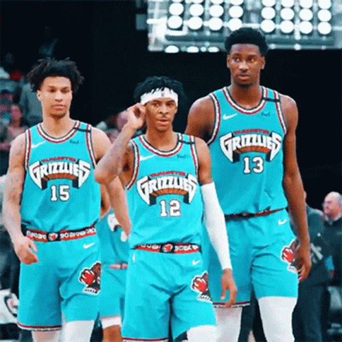 A Group Of Grizzlies Basketball Players Are Standing On The Court GIF