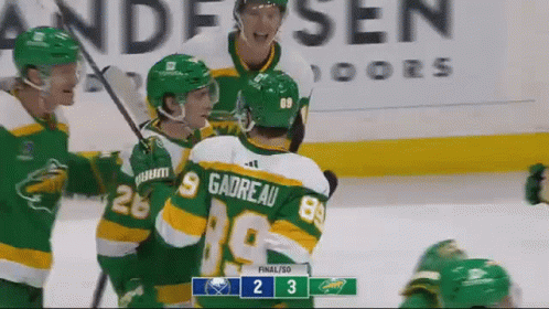 A Group Of Hockey Players Are Celebrating A Goal In Front Of A Scoreboard That Says 2 3 GIF