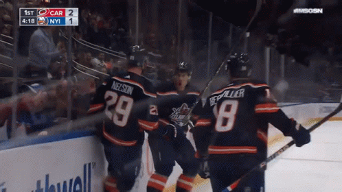 A Group Of Hockey Players Are Celebrating A Goal With The Number 29 On Their Jersey GIF