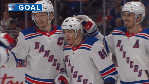 A Group Of Hockey Players Are Celebrating A Goal With The Word Goal Above Them GIF