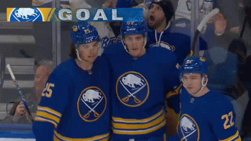 A Group Of Hockey Players Are Standing In Front Of A Goal Banner GIF