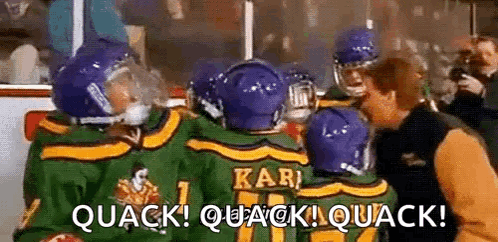 A Group Of Hockey Players Are Standing Next To Each Other On The Ice And Talking To Each Other . GIF