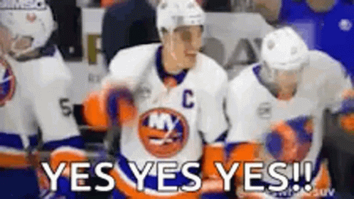 A Group Of Hockey Players Are Standing On The Ice And One Of Them Is Wearing A Jersey With The Letter C On It . GIF