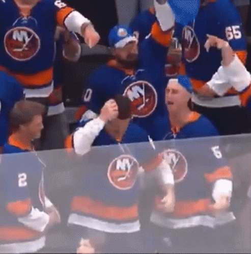 A Group Of Hockey Players Wearing Blue Jerseys With Ny On Them . GIF
