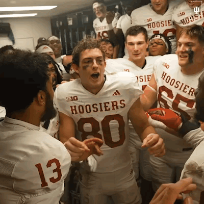 A Group Of Hoosier Football Players Are In A Locker Room GIF
