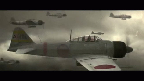 A Group Of Japanese Fighter Jets Are Flying In The Sky . GIF