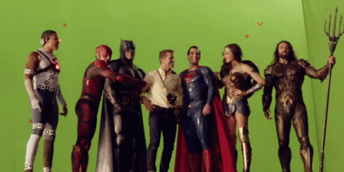 A Group Of Justice League Characters Are Posing For A Picture On A Green Screen GIF