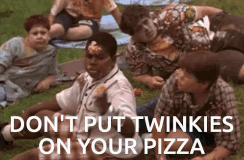 A Group Of Kids Are Laying On The Grass Eating Pizza And One Of Them Has Twinkies On His Face GIF