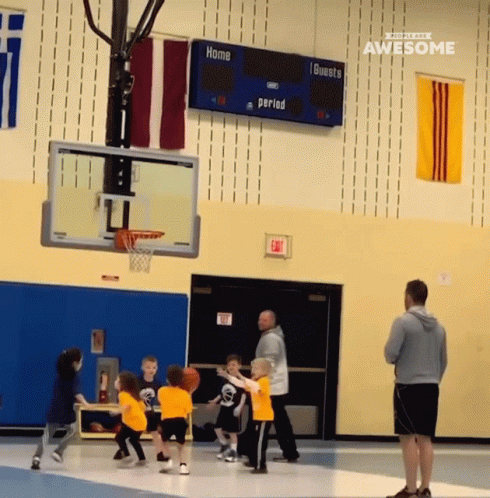 A Group Of Kids Are Playing Basketball In Front Of A Scoreboard That Says Home 1 Guests Period GIF