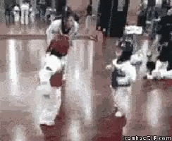 A Group Of Kids Are Practicing Martial Arts In A Gym GIF