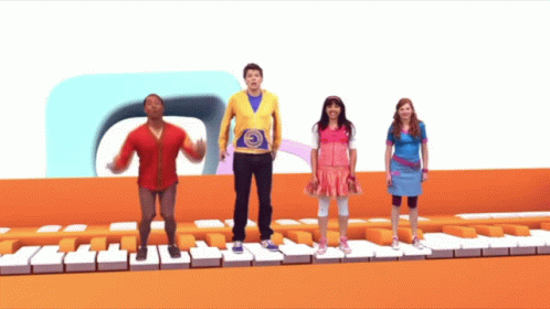 A Group Of Kids Are Standing On A Piano Keyboard GIF