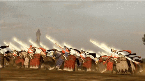 A Group Of Knights On Horses With Flames Behind Them GIF