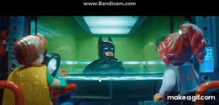A Group Of Lego Characters Are Looking At Batman Through A Glass GIF