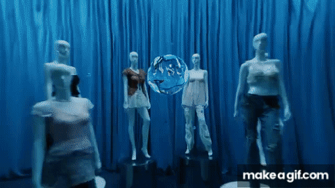 A Group Of Mannequins Are Standing In Front Of A Blue Curtain With A Make A Gif.com Logo GIF