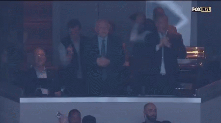 A Group Of Men Applaud In A Fox Nfl Stadium GIF