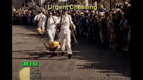 A Group Of Men Are Carrying A Bunch Of Cheese On A Cart While A Crowd Watches GIF