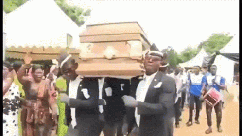 A Group Of Men Are Carrying A Coffin While Dancing . GIF