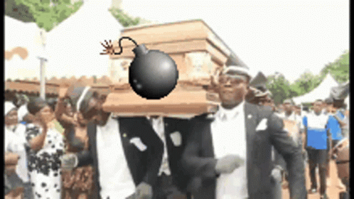A Group Of Men Are Carrying A Coffin With A Bomb On It 'S Head GIF