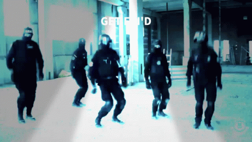 A Group Of Men Are Dancing In A Dark Room And The Words Get I 'D Are Visible In The Background GIF