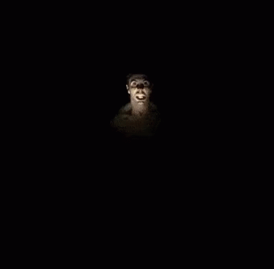 A Group Of Men Are Dancing In A Dark Room With A Man Standing In The Middle . GIF