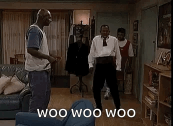 A Group Of Men Are Dancing In A Living Room With The Words `` Woo Woo Woo '' Written On The Screen . GIF