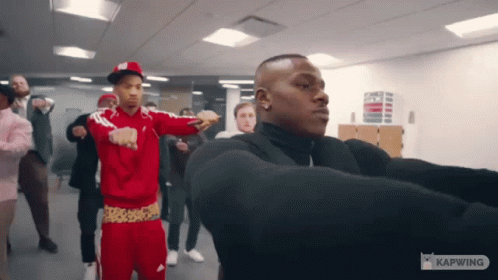 A Group Of Men Are Dancing In A Room With The Word Kapwing On The Bottom GIF