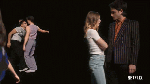 A Group Of Men Are Dancing In Front Of A Black Background With Netflix Written On The Bottom GIF