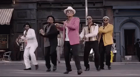 A Group Of Men Are Dancing In Front Of A Building . GIF