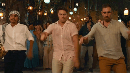 A Group Of Men Are Dancing In Front Of A Crowd Of People At A Party . GIF