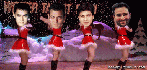A Group Of Men Are Dancing In Front Of A Sign That Says Christmas GIF