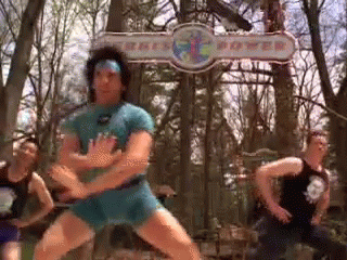A Group Of Men Are Dancing In Front Of A Sign That Says ' Kings Power ' GIF