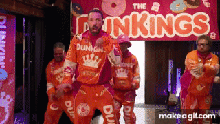 A Group Of Men Are Dancing In Front Of A Sign That Says The Dunkin ' Kings GIF
