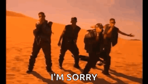 A Group Of Men Are Dancing In The Desert With The Words `` I 'M Sorry '' Written On The Bottom . GIF