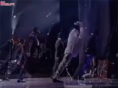 A Group Of Men Are Dancing On A Stage With A Man In A White Shirt Leading The Way . GIF